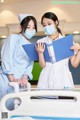 two nurses standing next to each other in a hospital room