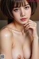 A naked asian woman with short brown hair posing for the camera.