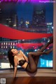 A woman in a black lingerie laying on a window sill.